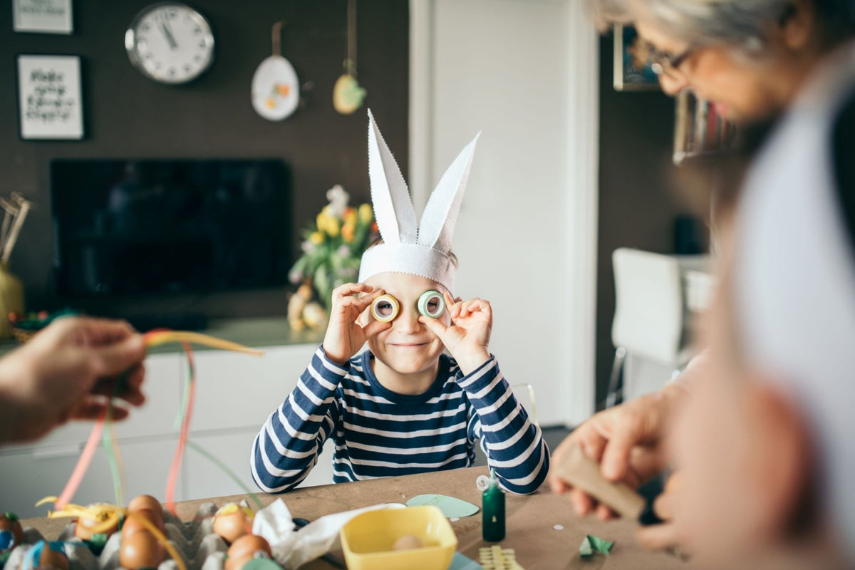 Young boy wearing paper bunny ears