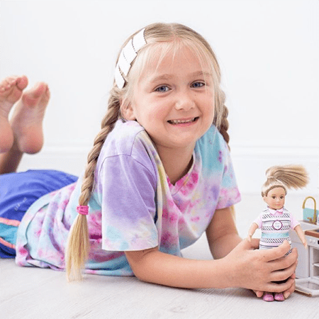 Girl playing with dolls.