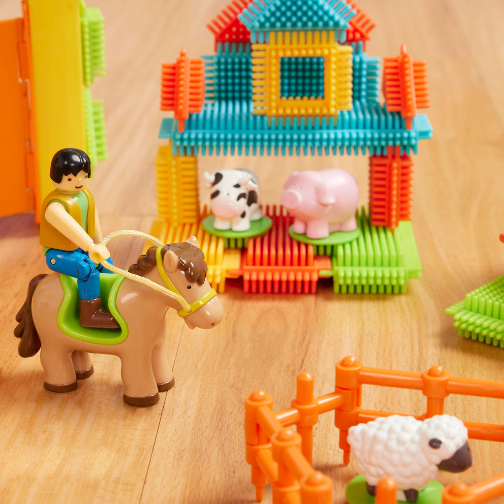 A 67-piece building block set with a farm theme, the set is laid out to show all the pieces, including animals, trees, and tractor.