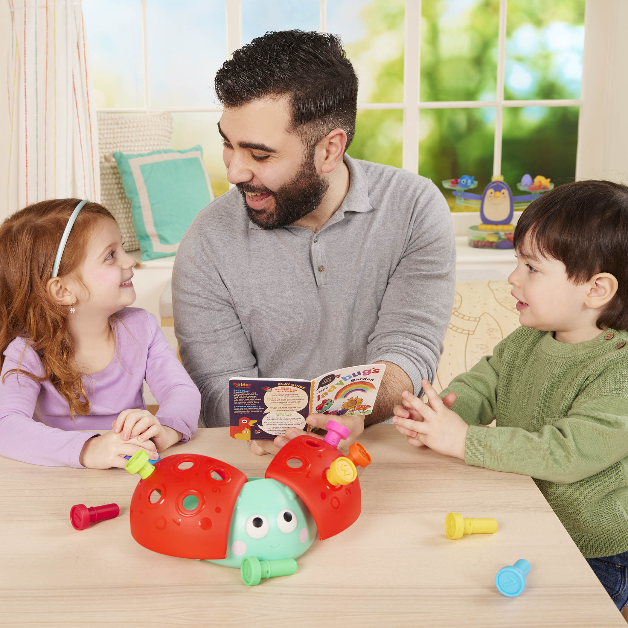 Colorful ladybug peg toy with booklet.