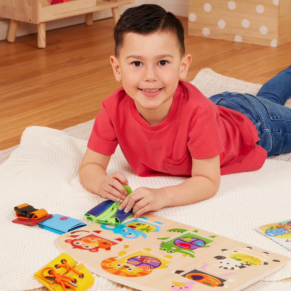 Booklet and basic skills board with animal illustrations and fasteners.