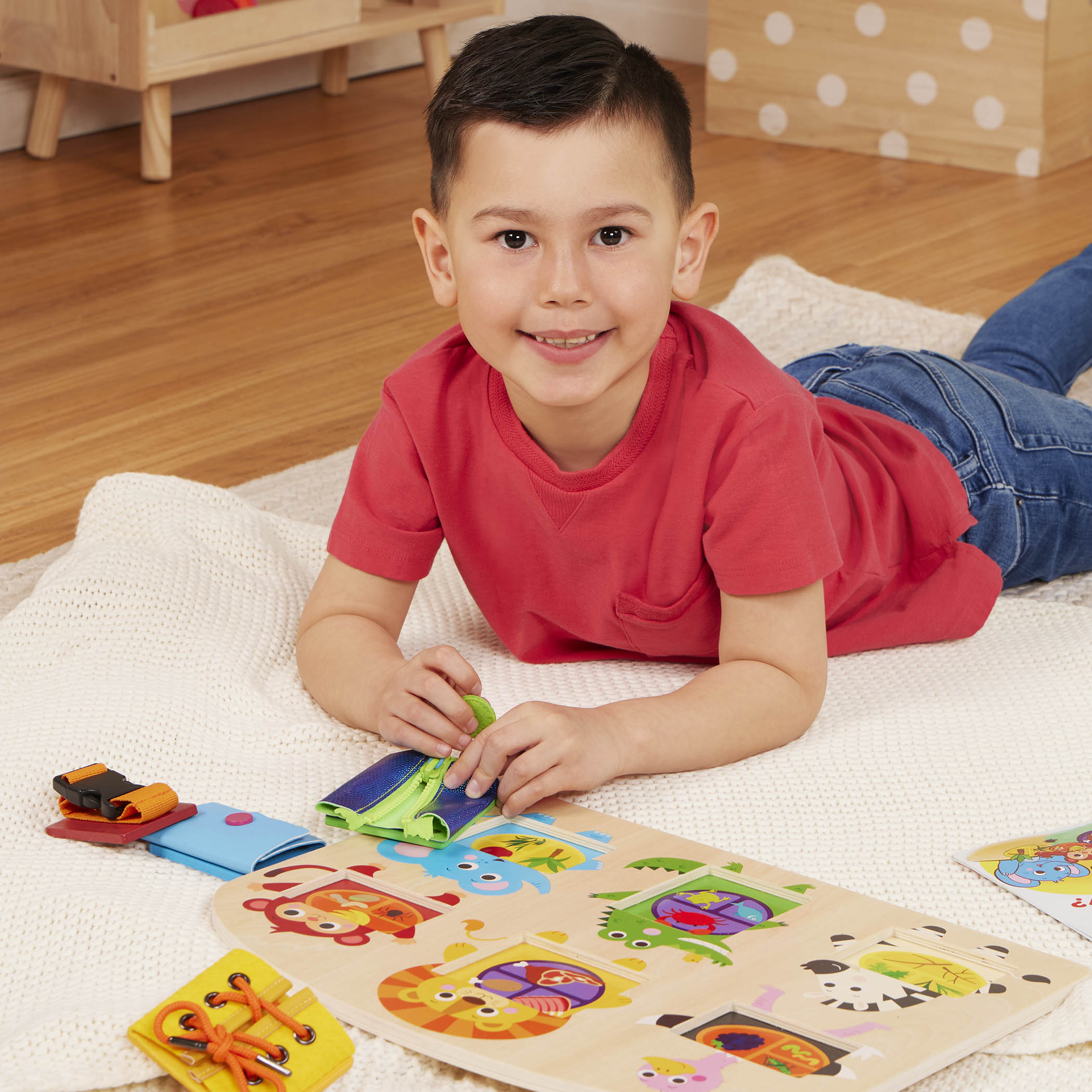 Booklet and basic skills board with animal illustrations and fasteners.
