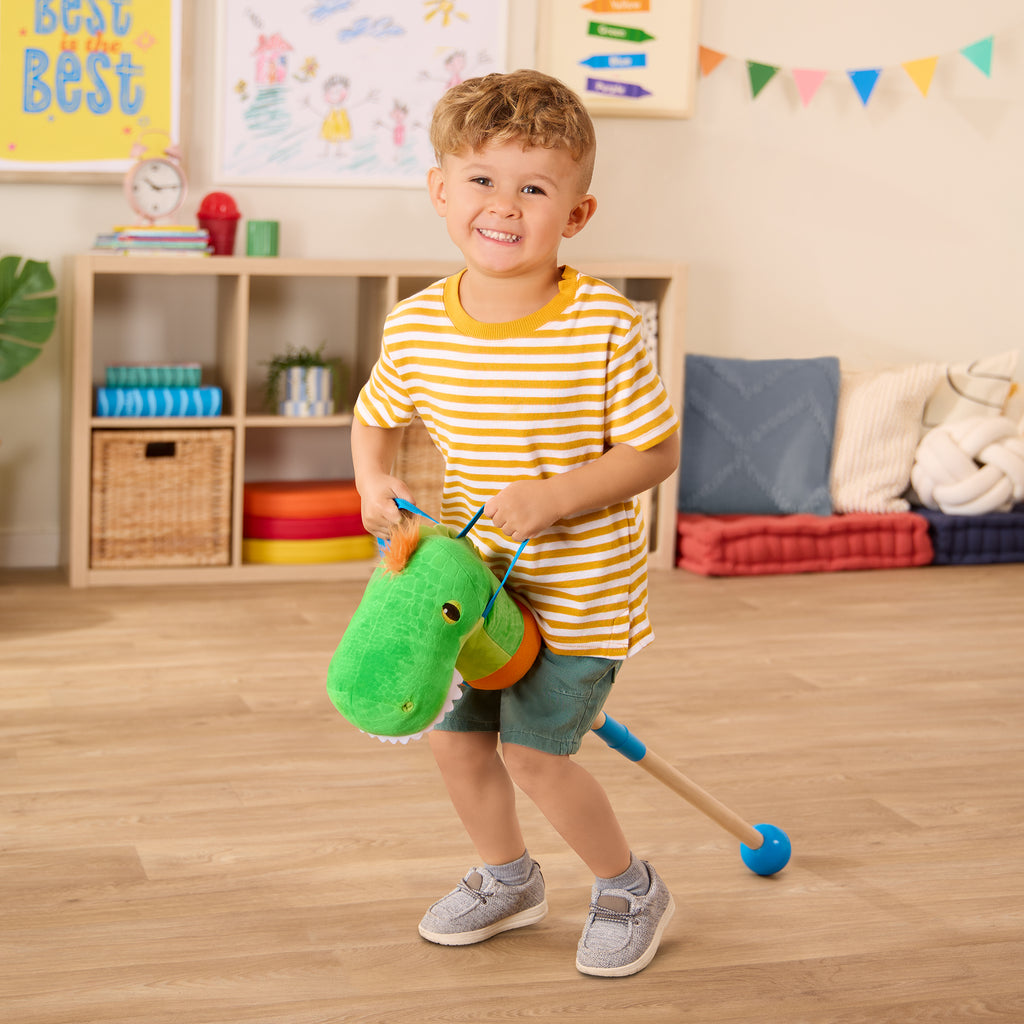 green dino hobby horse with wooden riding pole