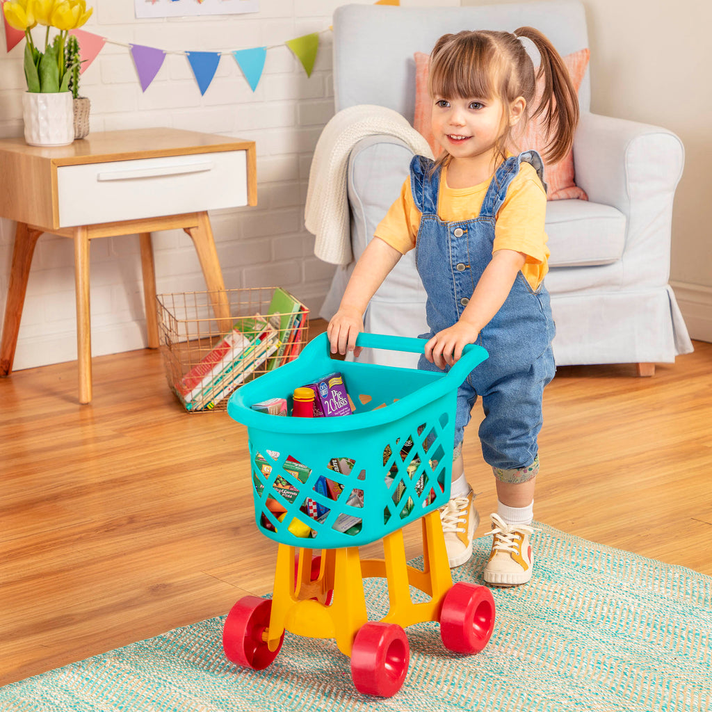 A blue, yellow, and red toy shopping cart complete with play food.