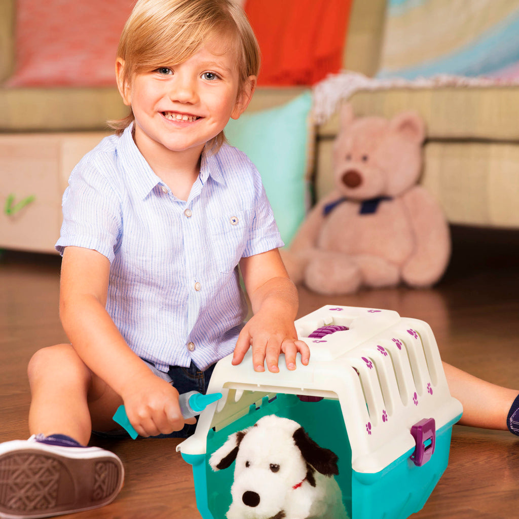 A toy vet kid for kids with a plush puppy in a carrier.
