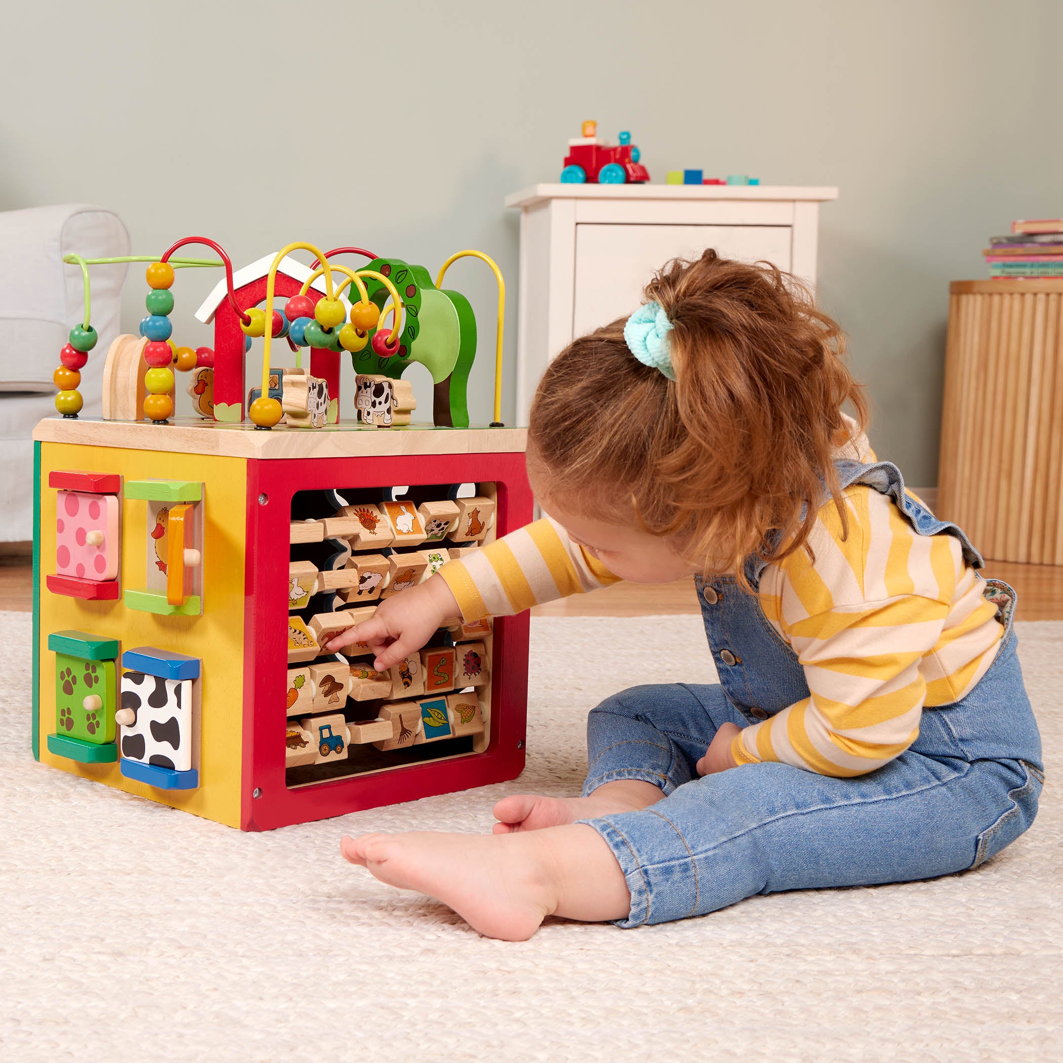 Farm animal activity center with a bead maze on top.
