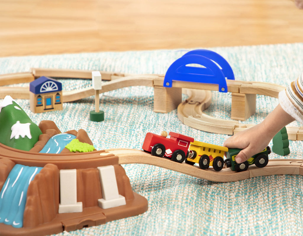 Storage that doubles as a mountain landscape with tracks over a pretend river.
