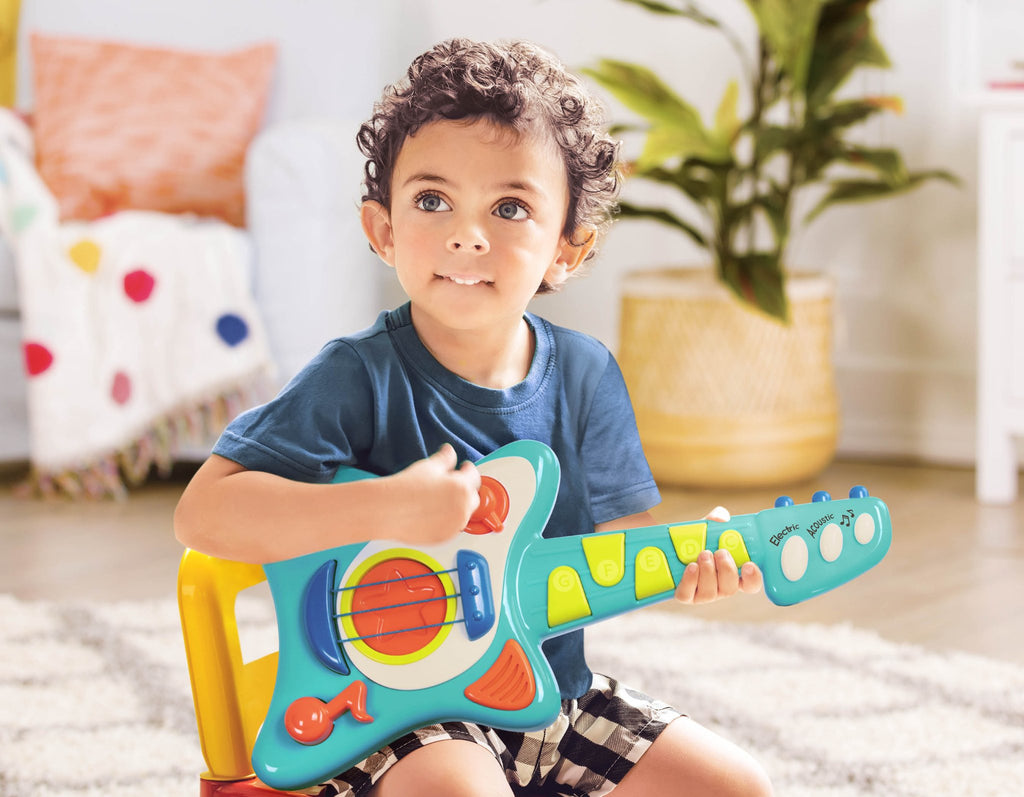 Toy guitar, with a blue body and green and orange buttons.