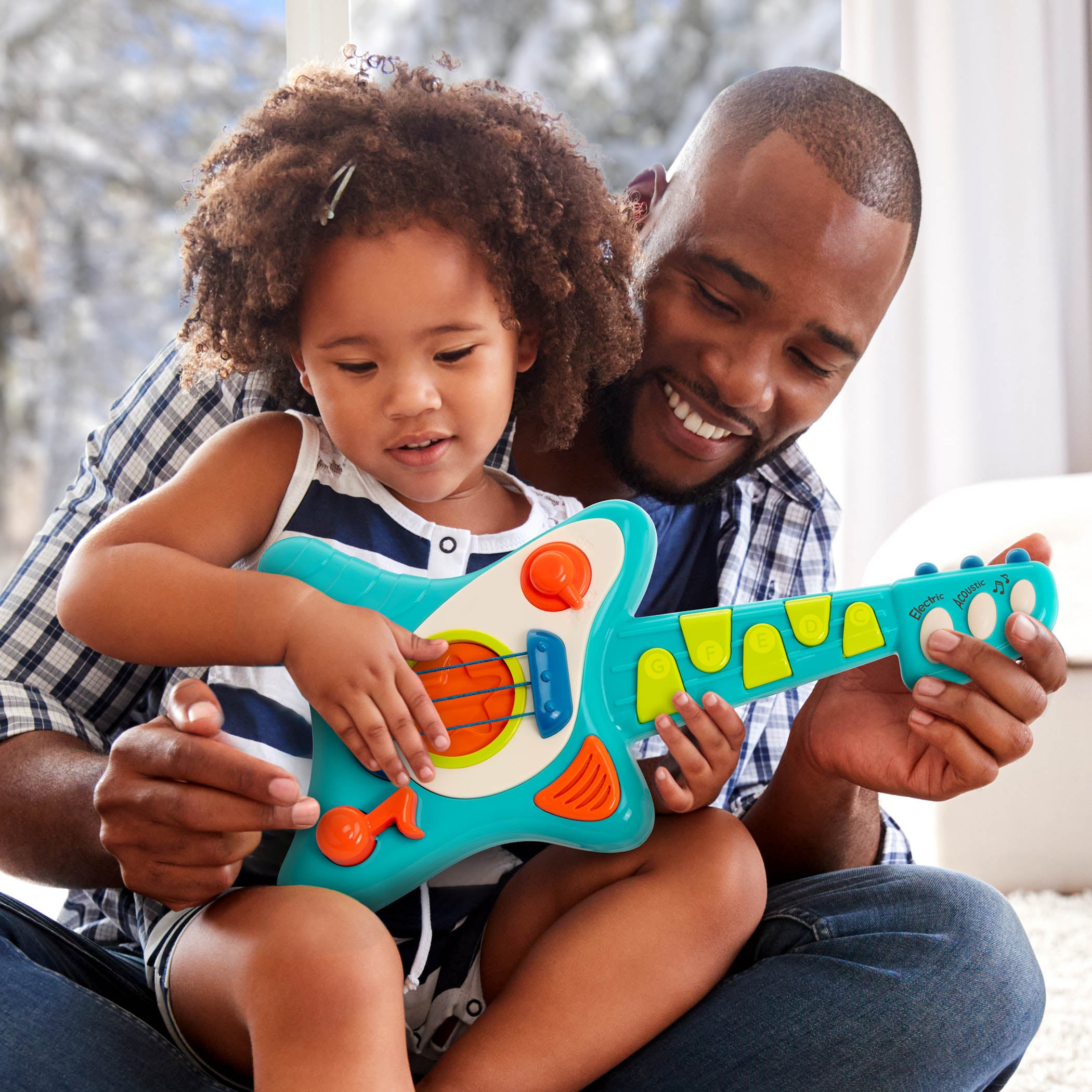 Toy guitar, with a blue body and green and orange buttons.