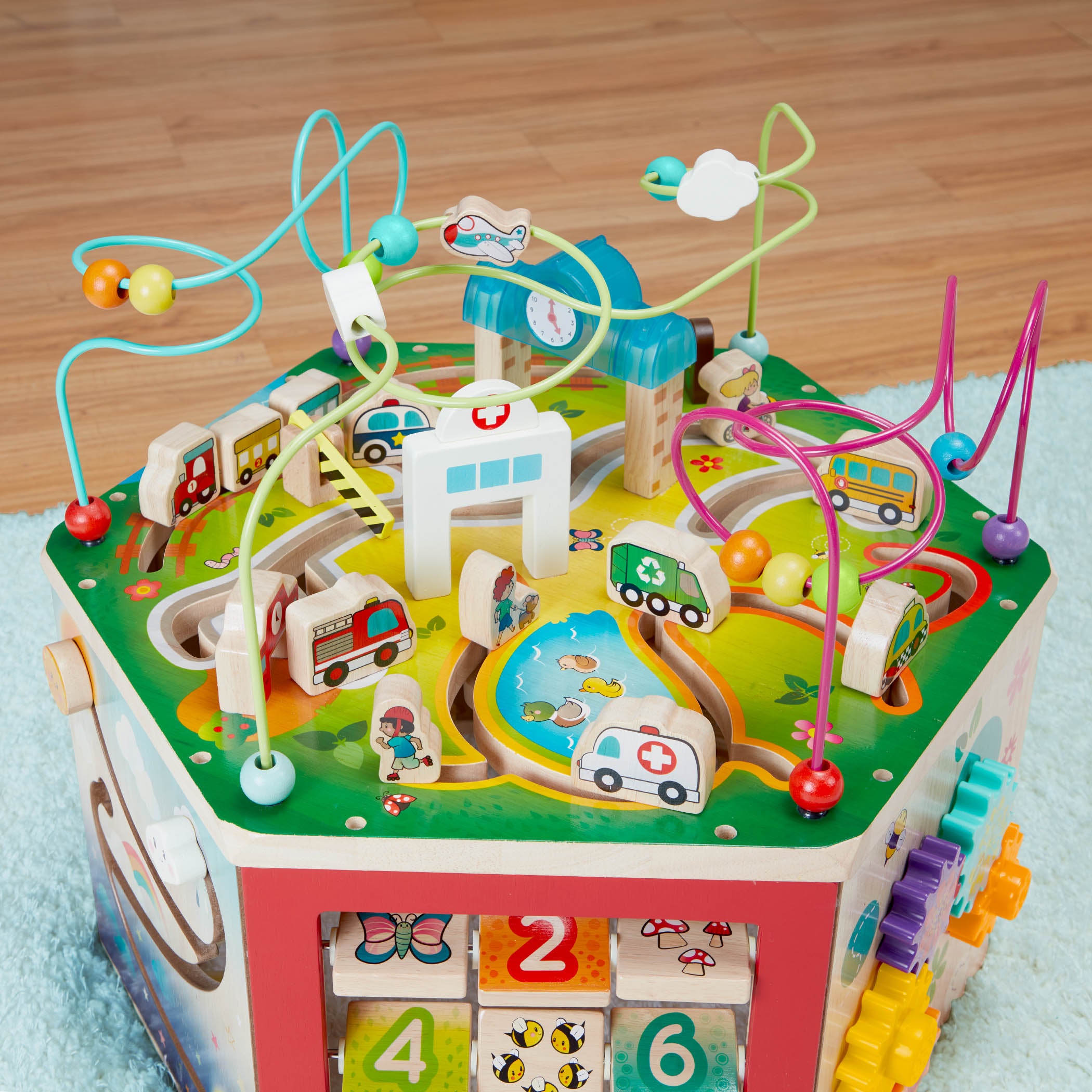 A 7-sided activity cube with a colorful pretend clock.