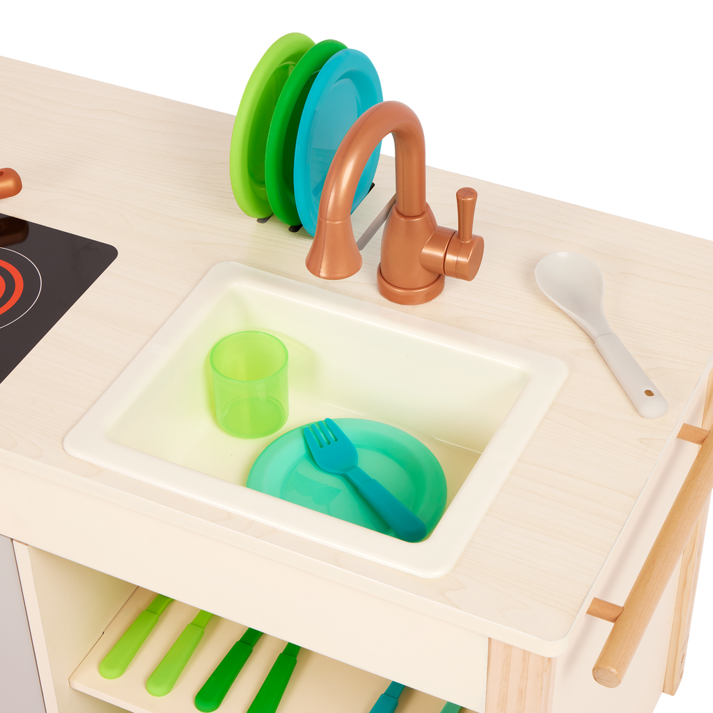 Wooden toy kitchen with colorful accessories.