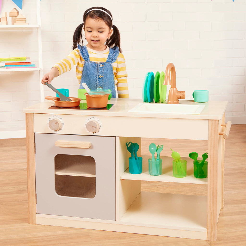 Wooden toy kitchen with colorful accessories.
