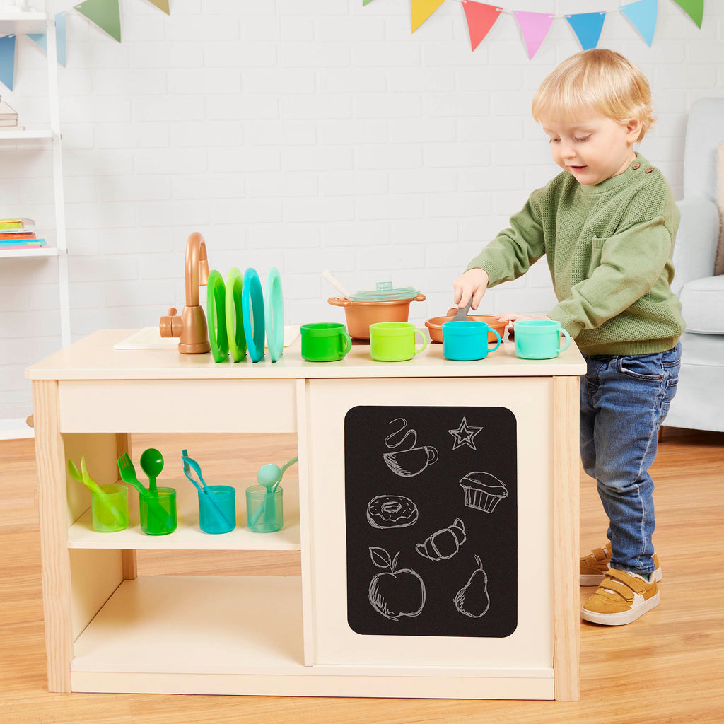 Wooden toy kitchen with colorful accessories.