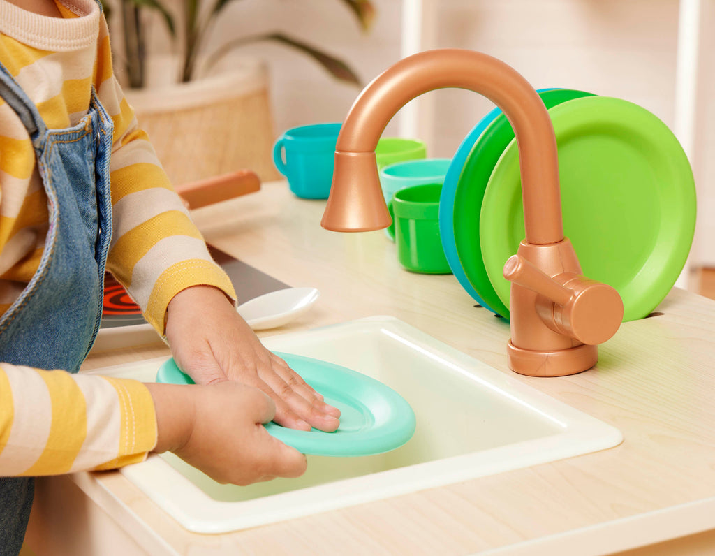 Wooden toy kitchen with colorful accessories.
