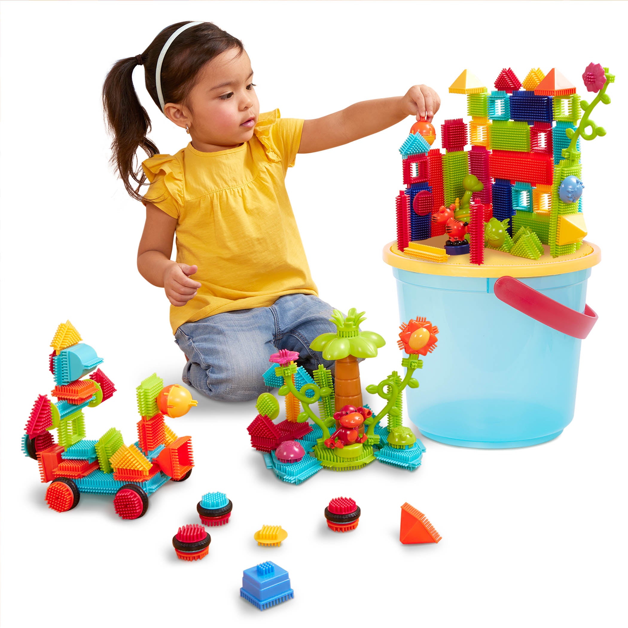 A vehicle and structure made with Bristle Blocks.