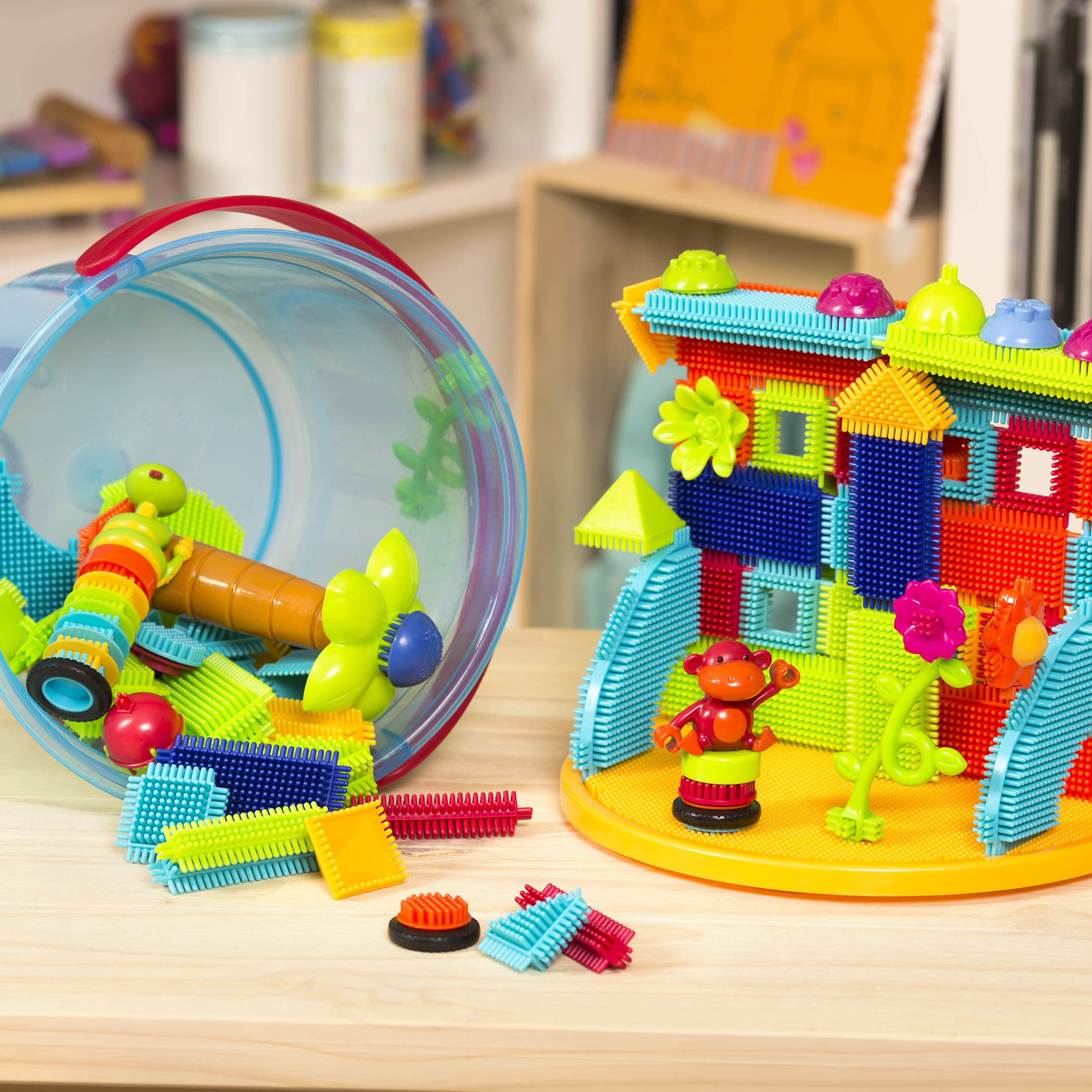 A vehicle and structure made with Bristle Blocks.