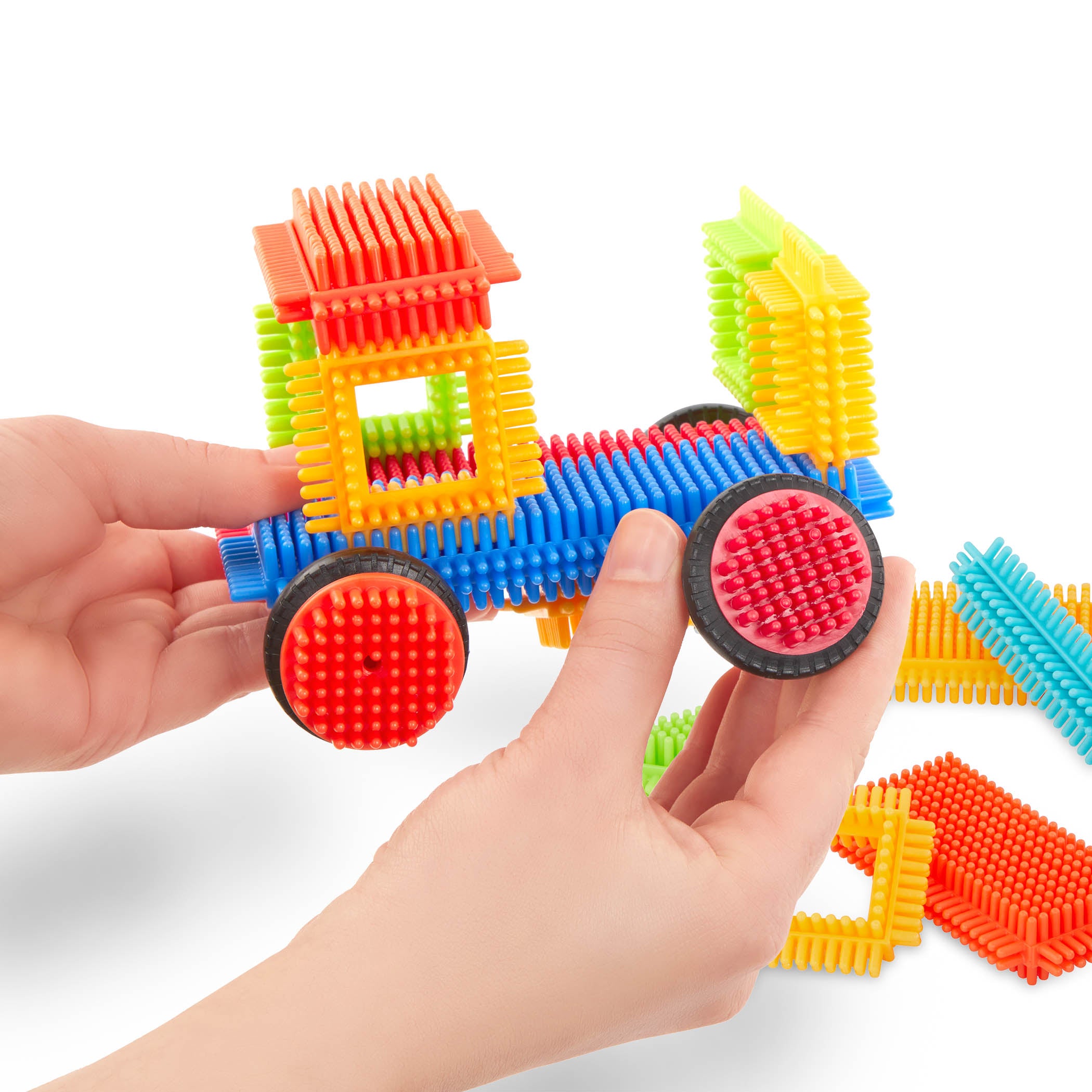 Creations made with Bristle Blocks, including a car with functional wheels.