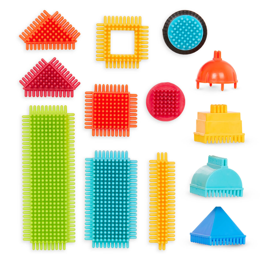 A colorful array of Bristle Blocks laid out so we can see all the pieces and the big reusable storage container.