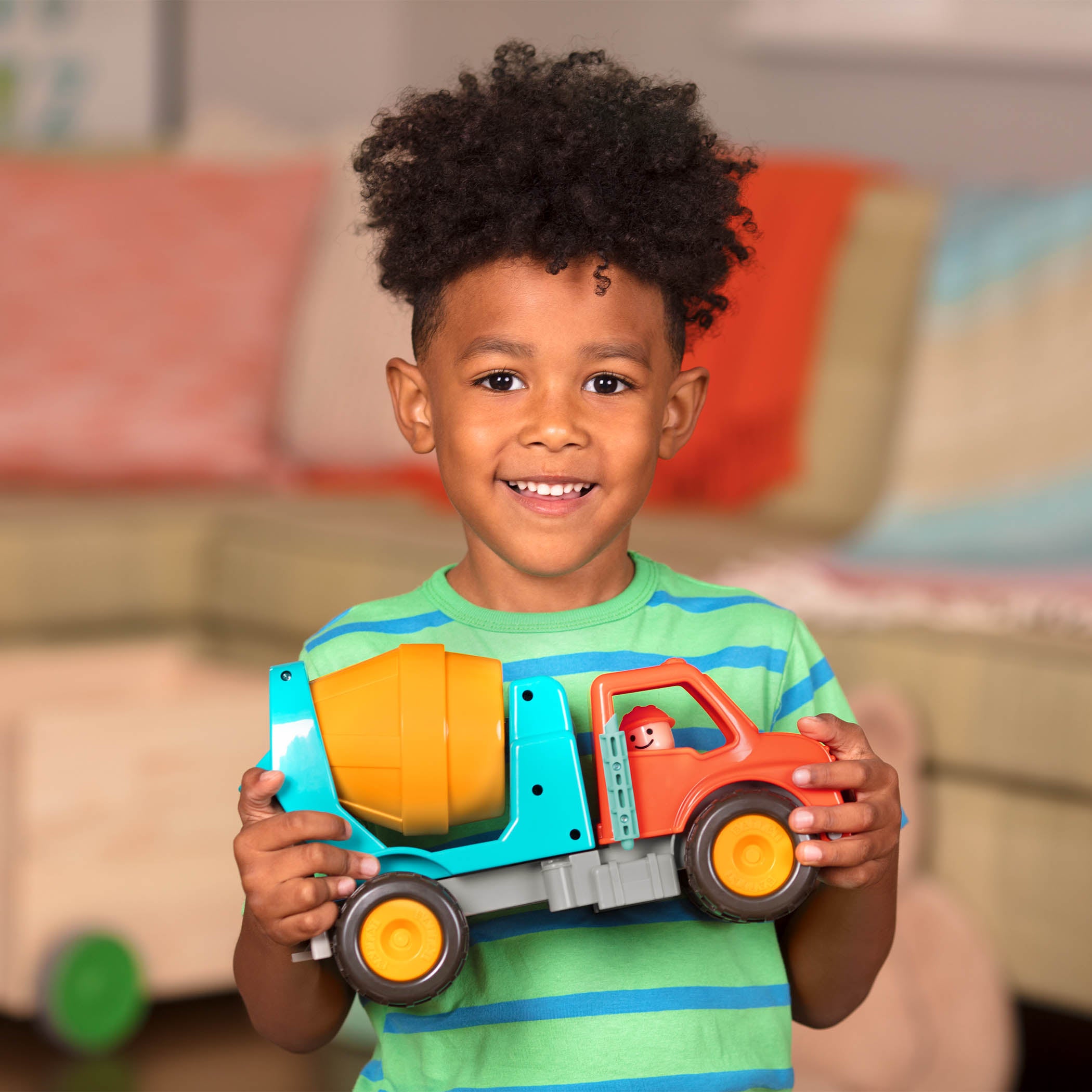 A toy cement mixing truck for kids and toddlers with a little driver figurine.