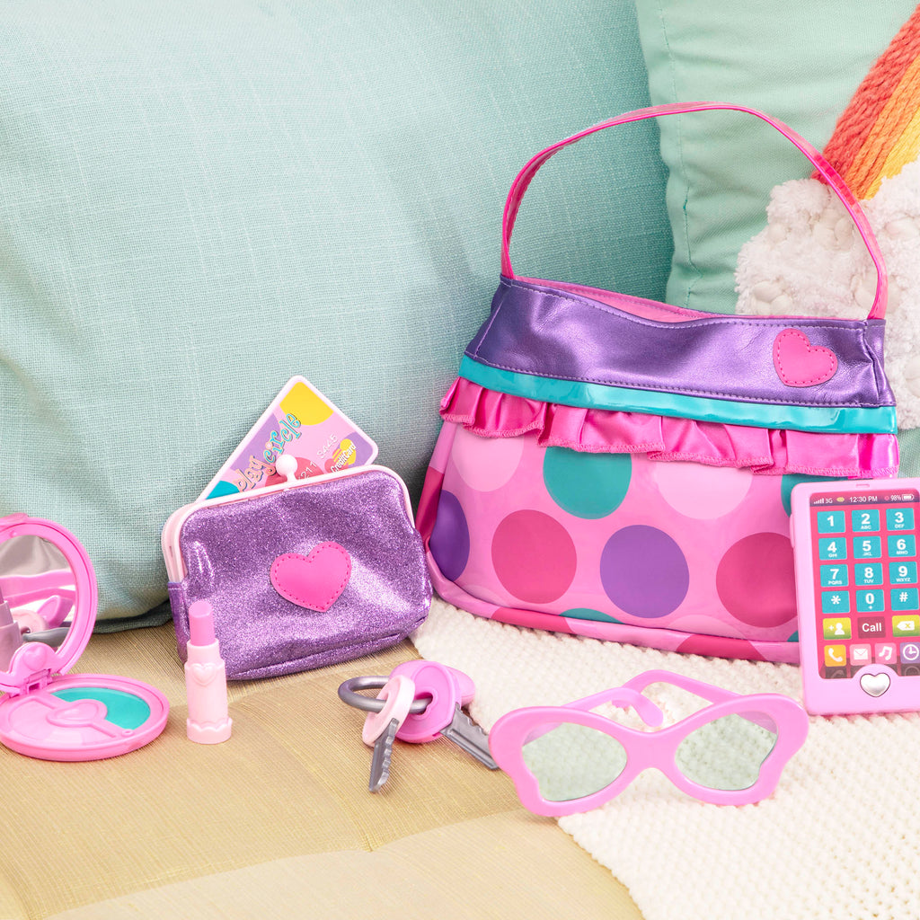 A pink and purple purse set for toddlers and kids, it comes with accessories like a compact mirror, pretend lipstick, coin purse, and more.