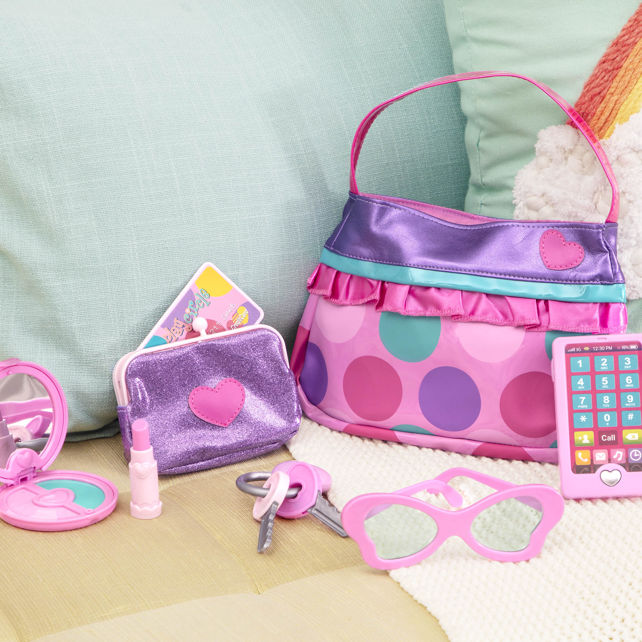A pink and purple purse set for toddlers and kids, it comes with accessories like a compact mirror, pretend lipstick, coin purse, and more.