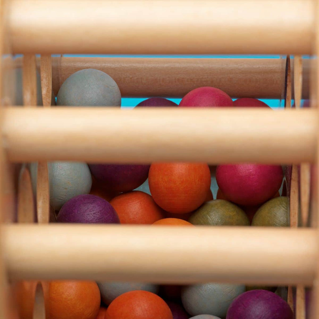 Rolling tower filled with colorful wooden marbles