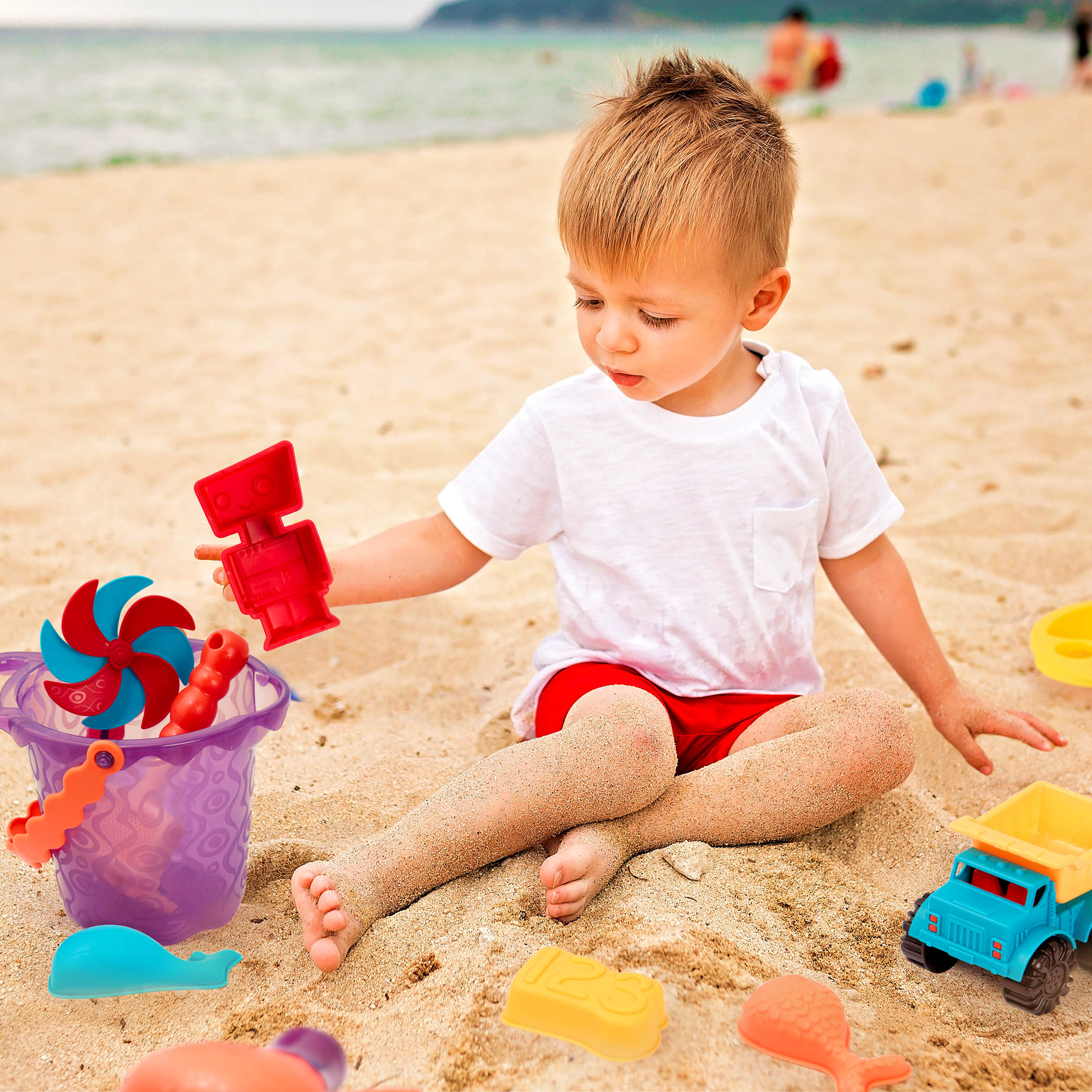 Beach toys with purple bucket.