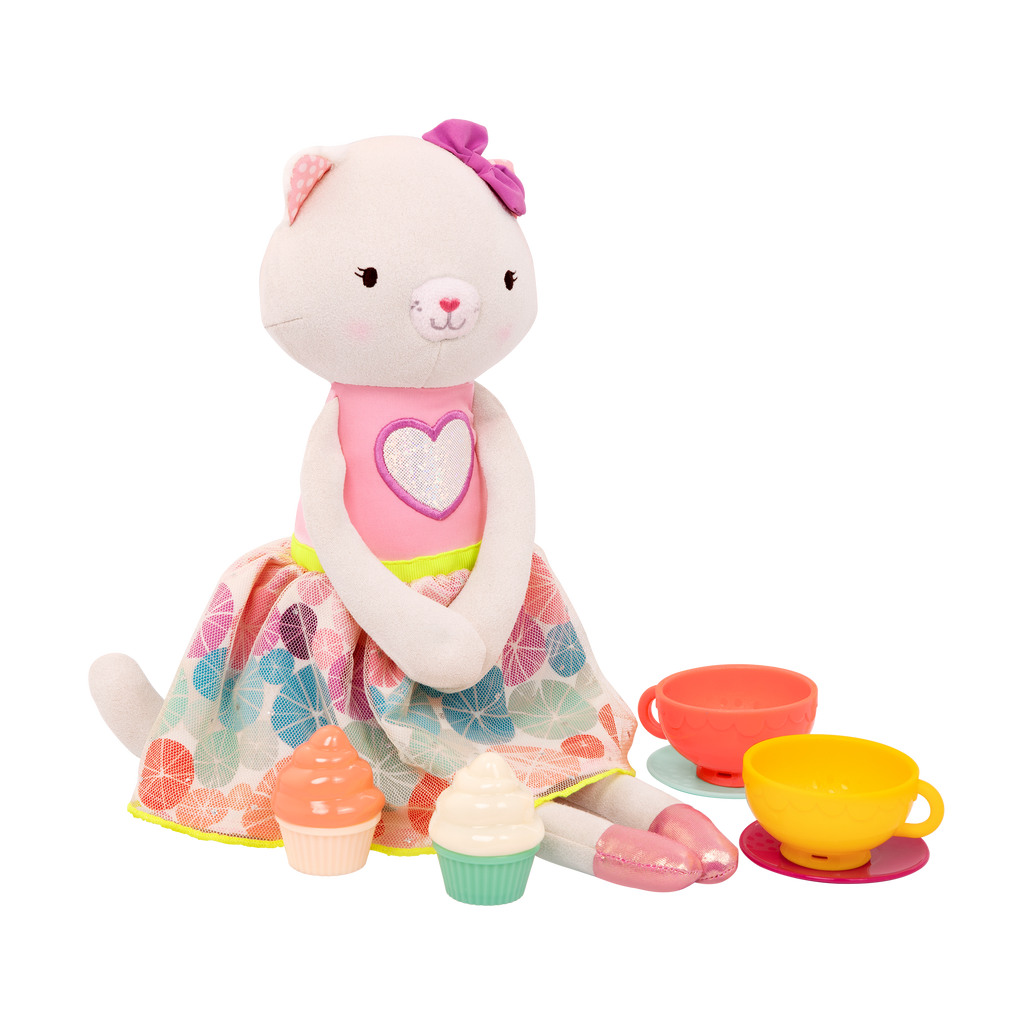 Tea set with plush cat and book.