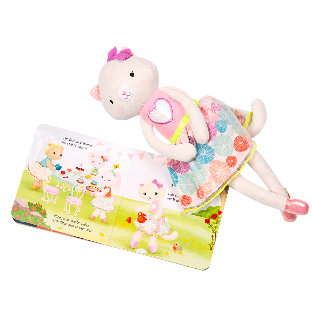 Tea set with plush cat and book.