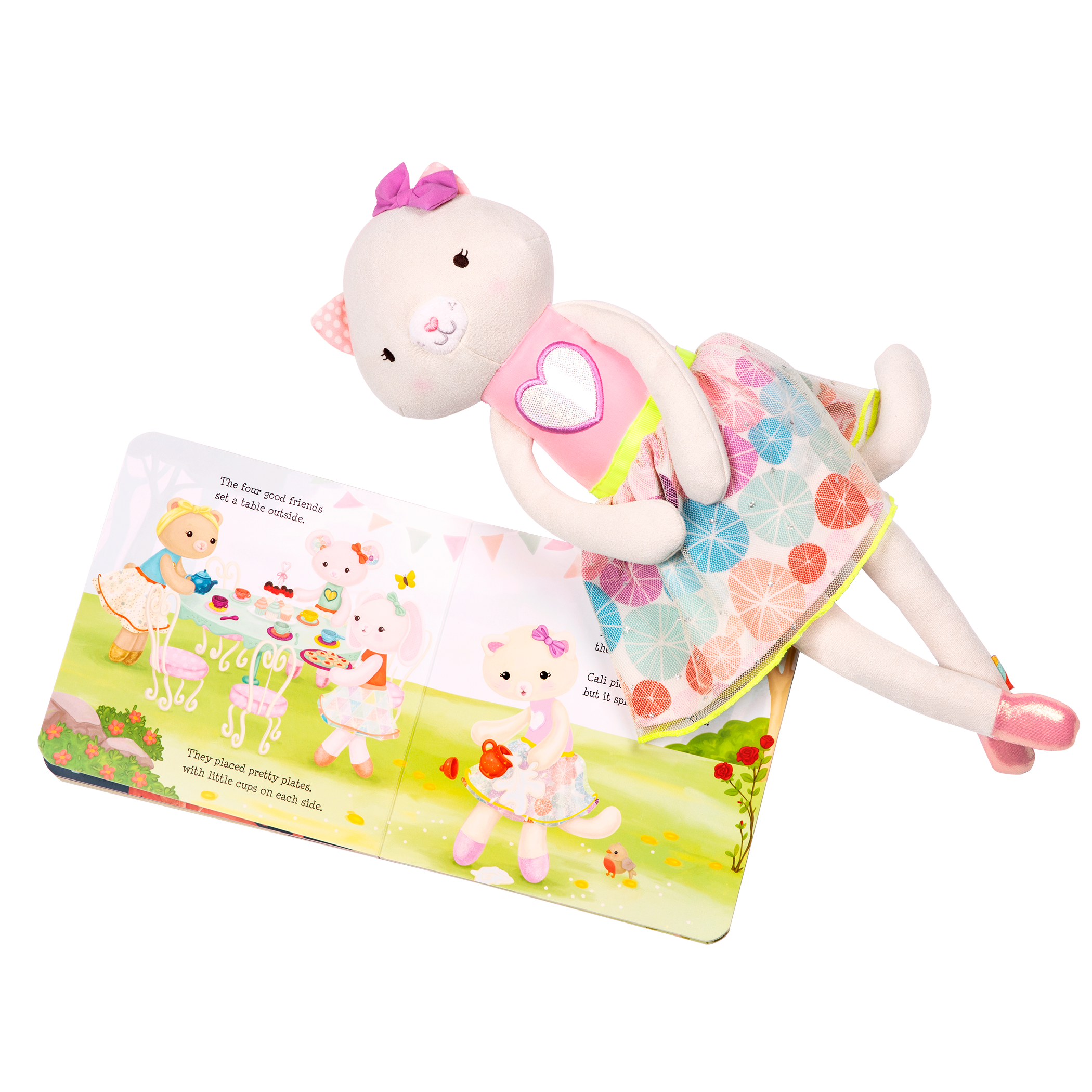 Tea set with plush cat and book.