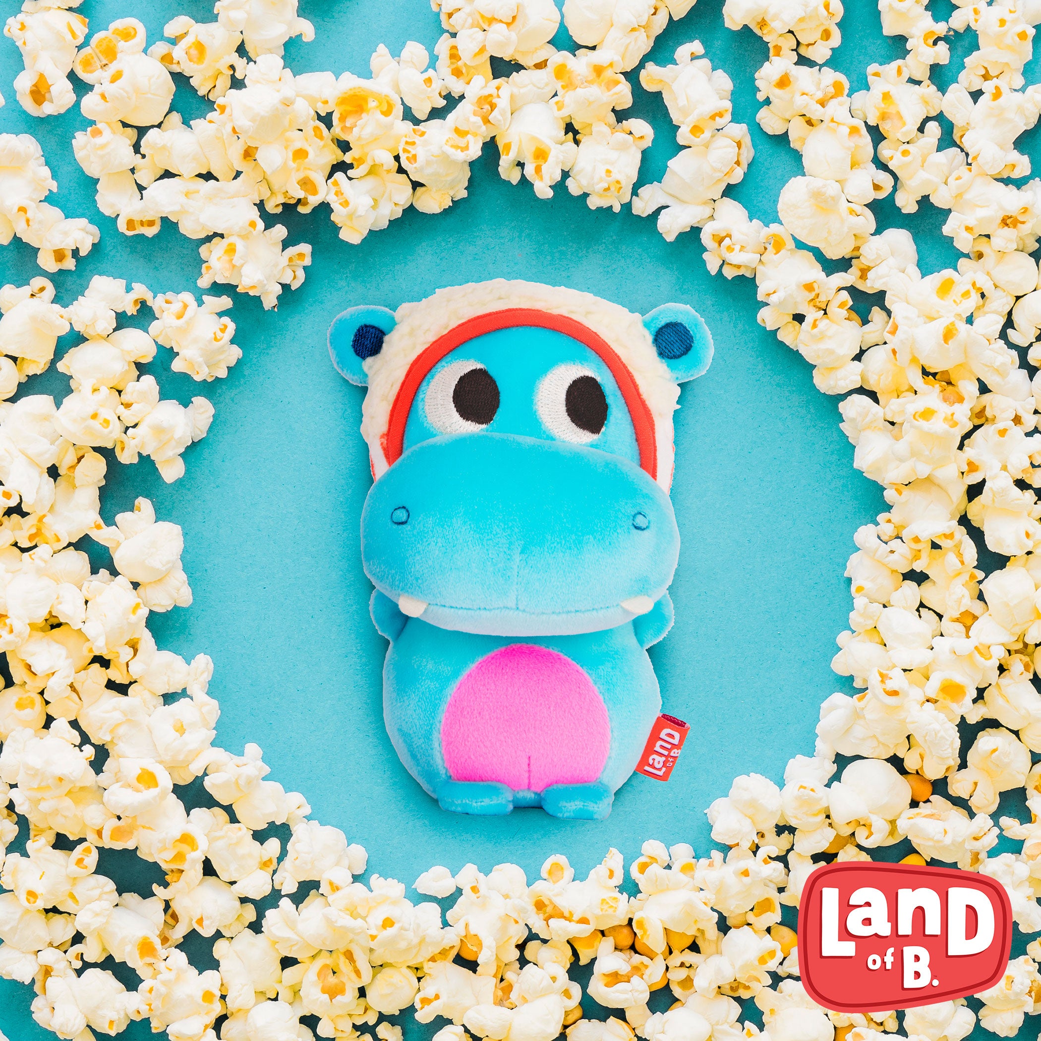 Plush hippo with a popcorn hood.