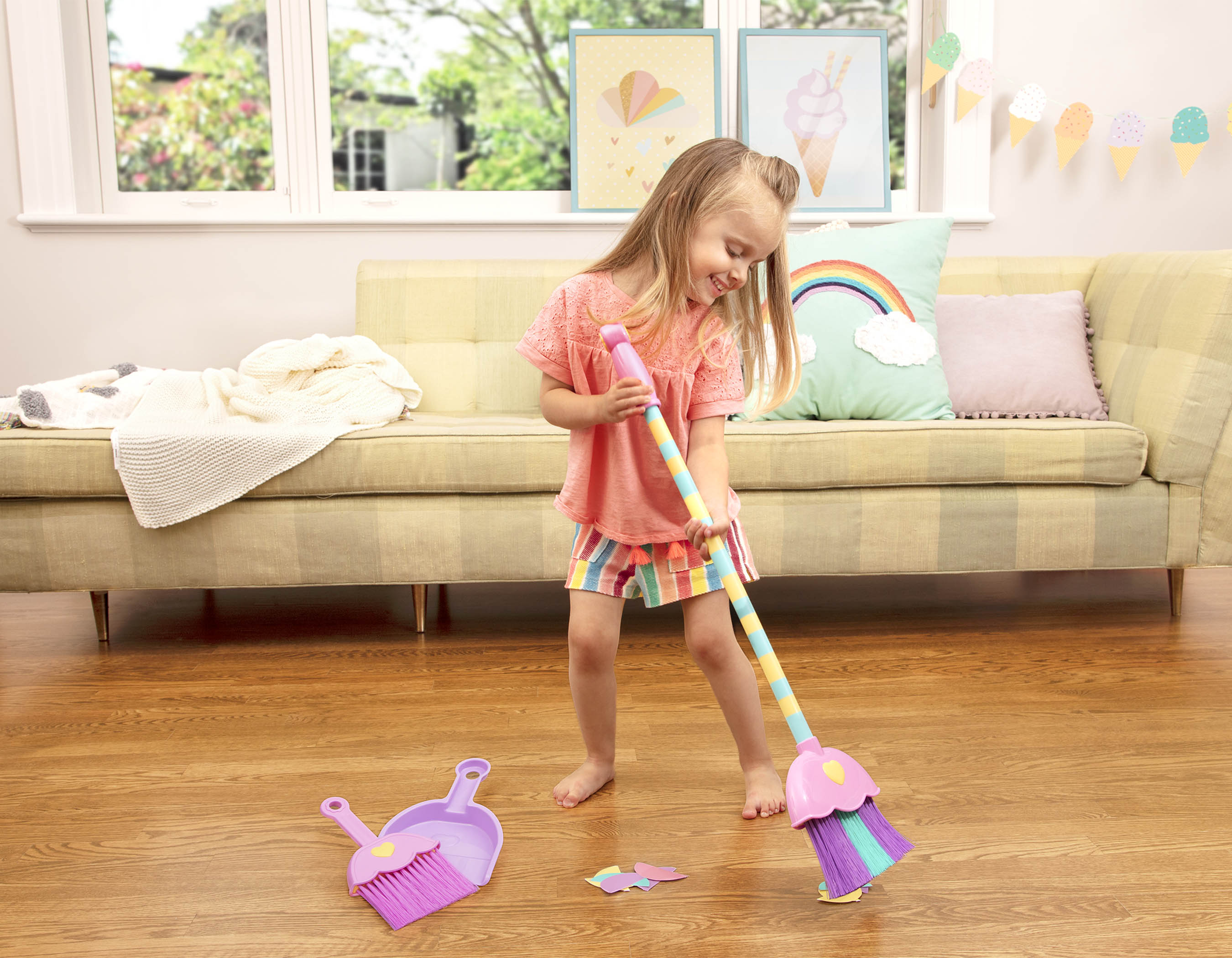 A toy broom, brush, and dustpan.