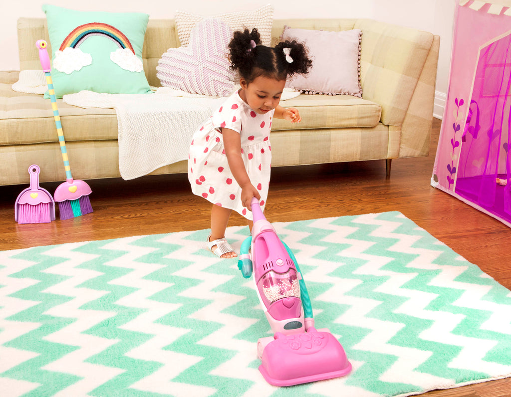 A pink toy vacuum for toddlers and kids.