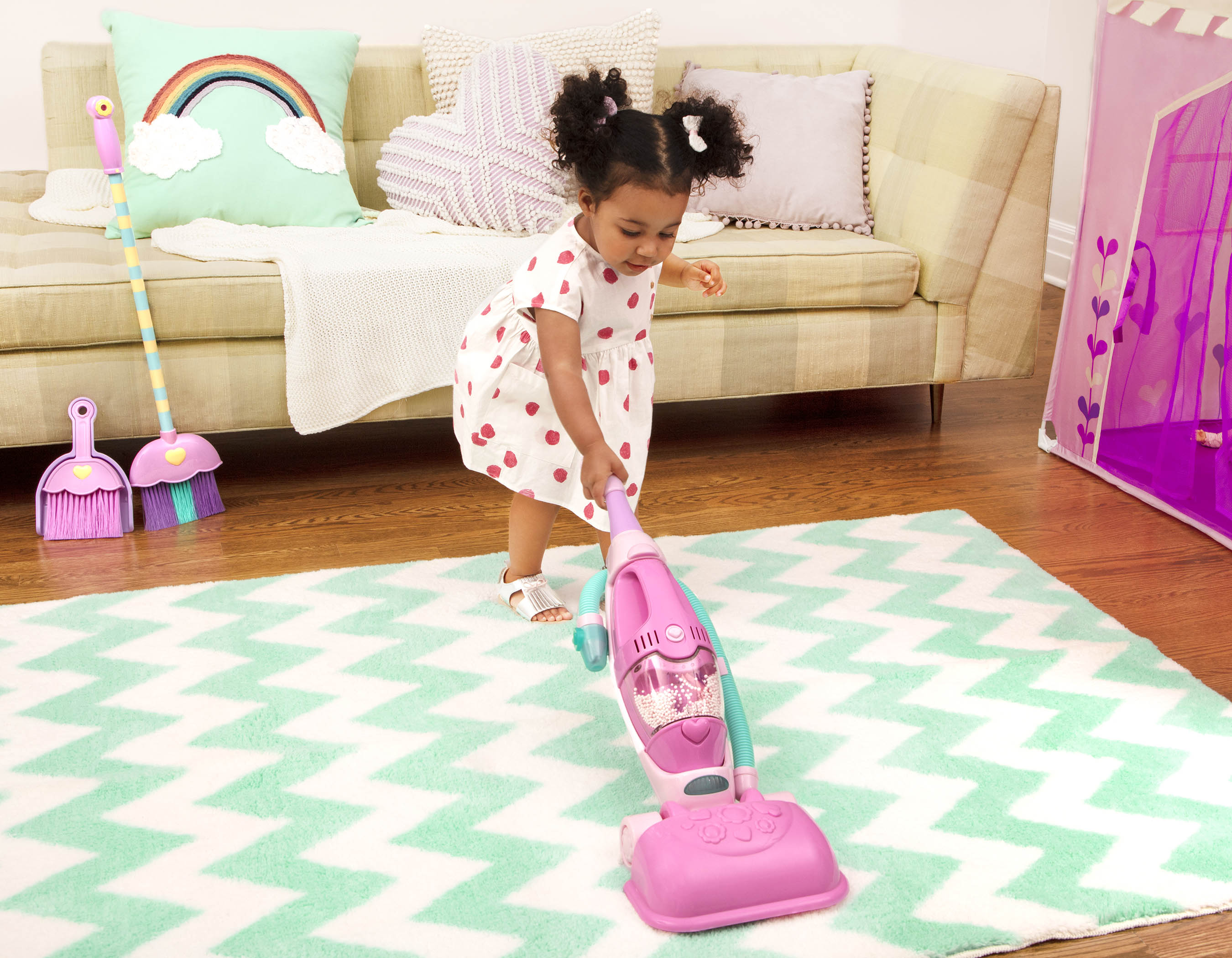 A pink toy vacuum for toddlers and kids.