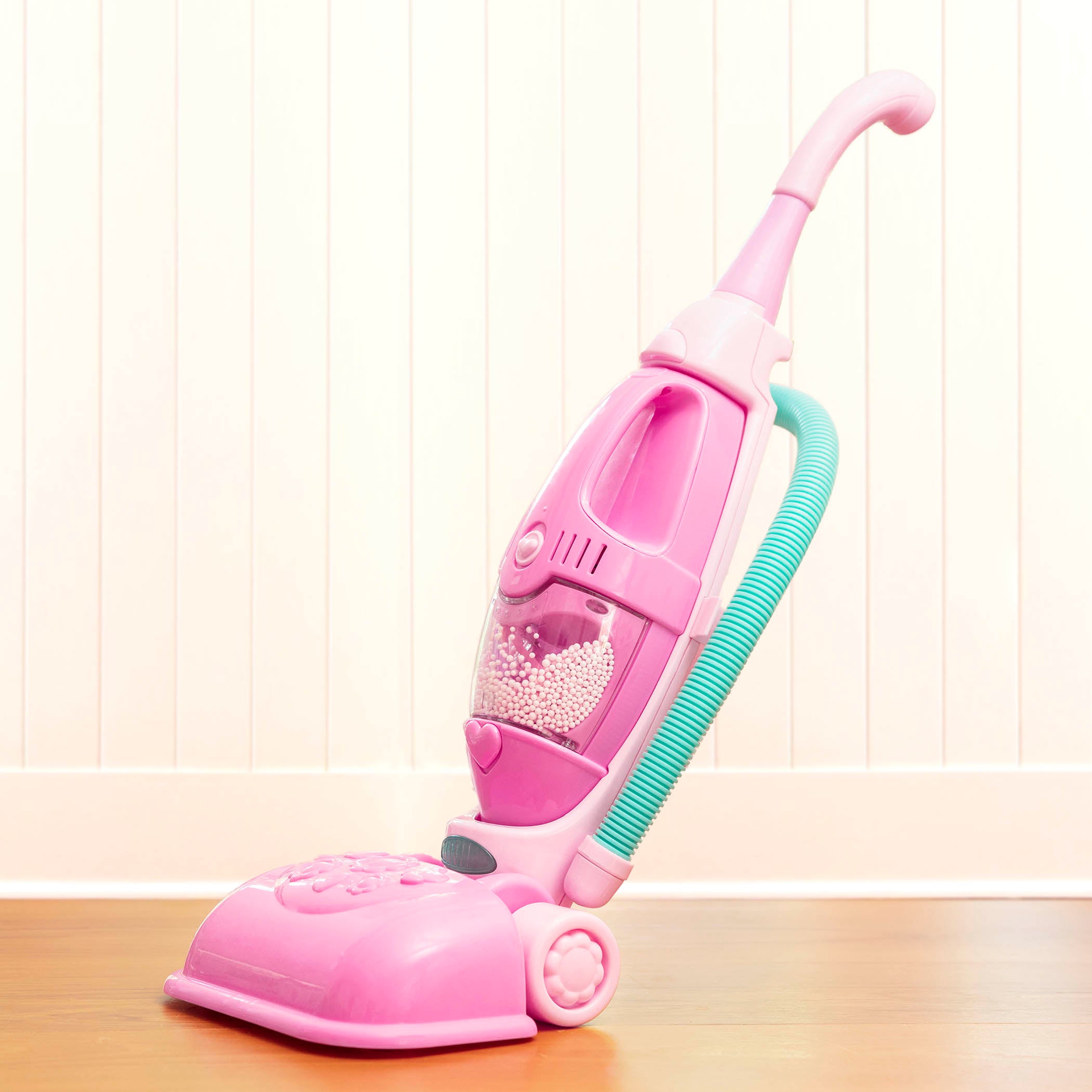 A pink toy vacuum for toddlers and kids.