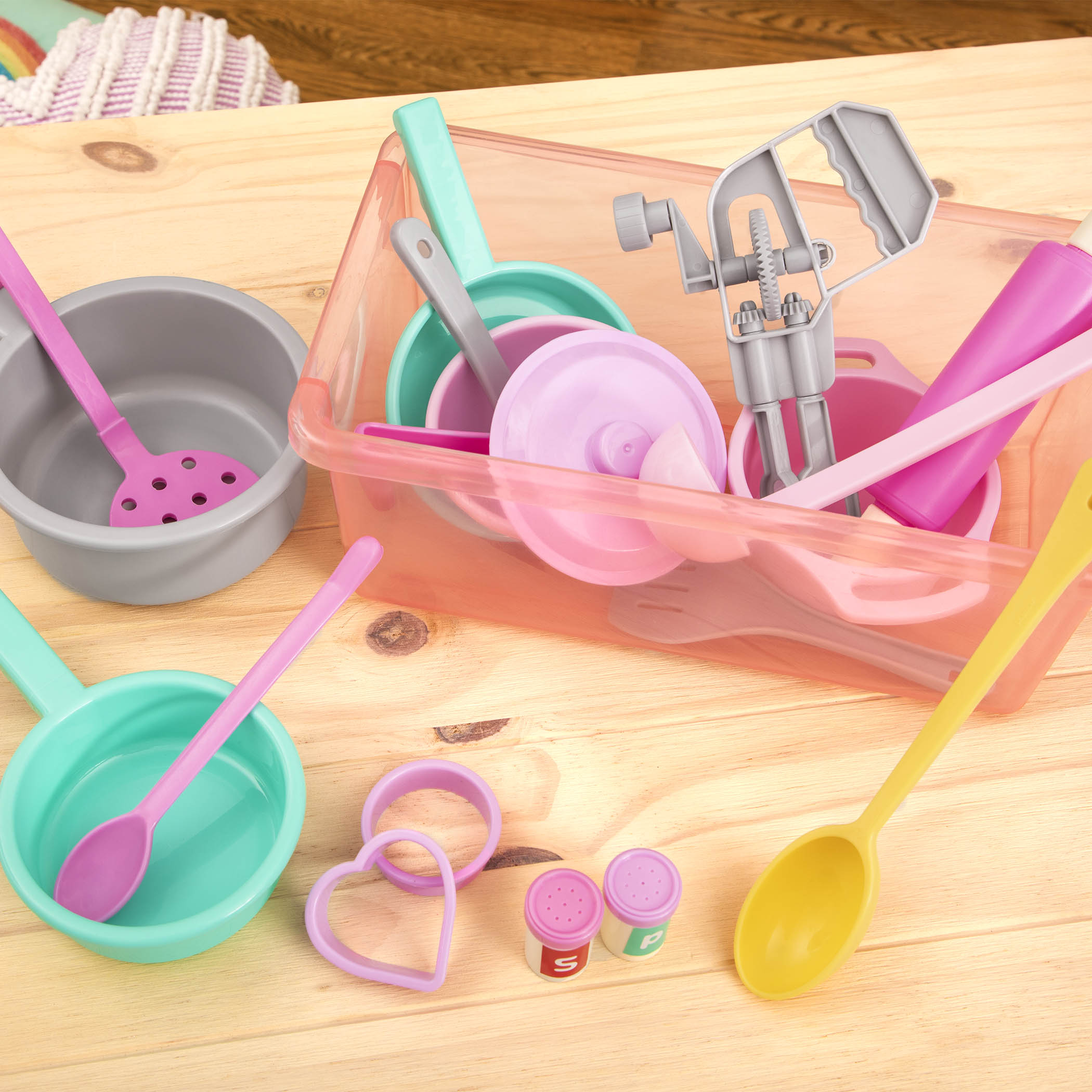 A colorful set of kitchen toys with a bin to store verything in.