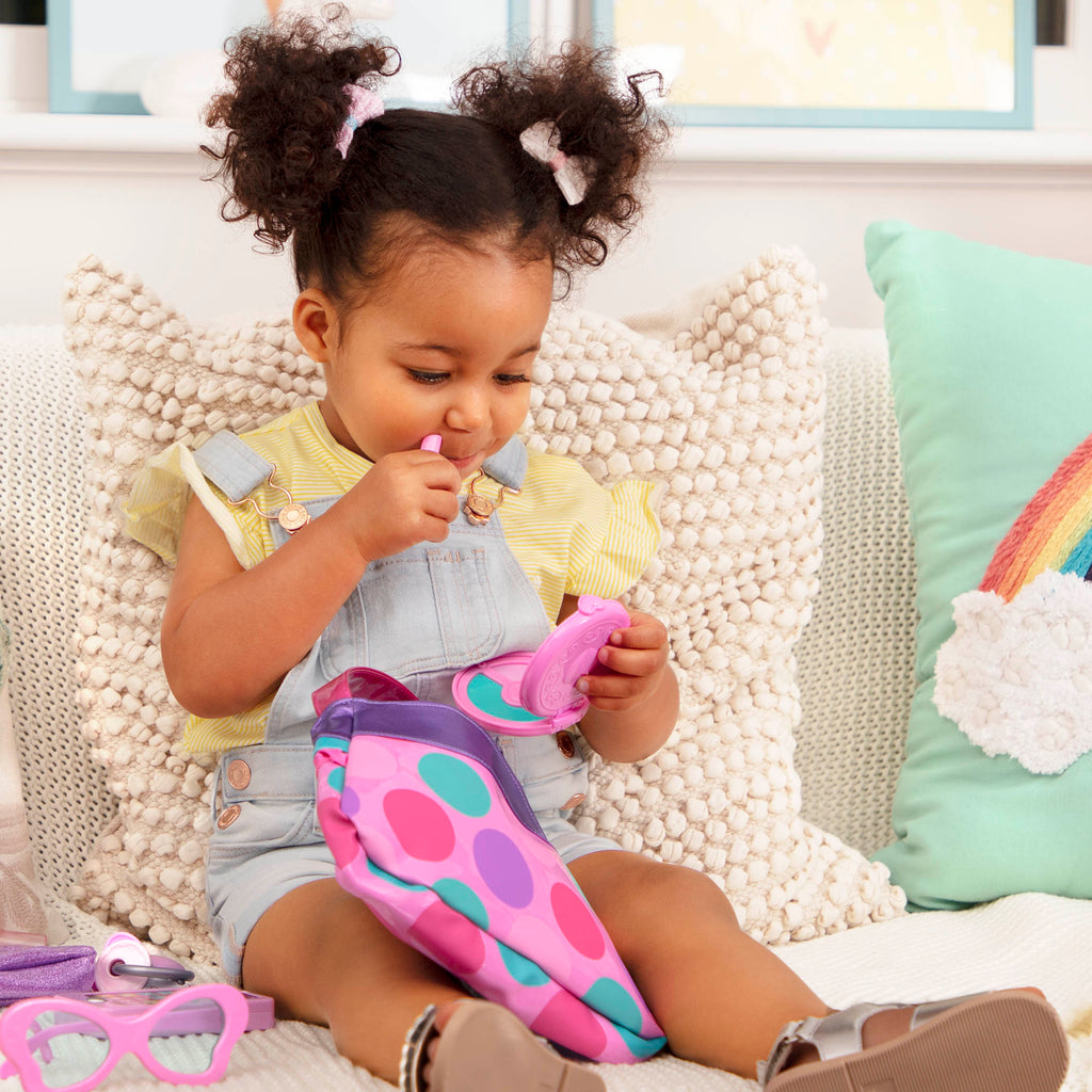 A pink and purple purse set for toddlers and kids, it comes with accessories like a compact mirror, pretend lipstick, coin purse, and more.