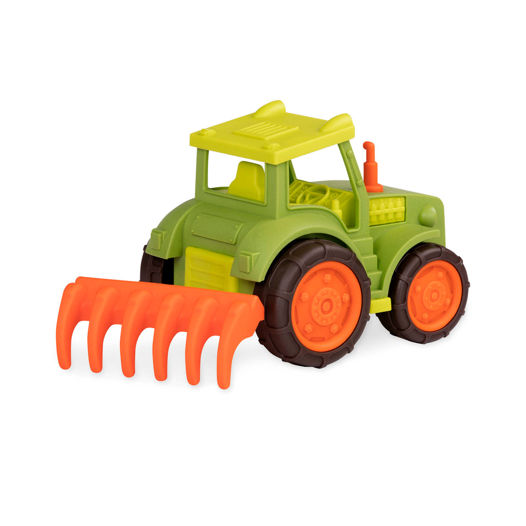 A green and orange tractor toy with a rake in the back.