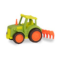 A green and orange tractor toy with a rake in the back.