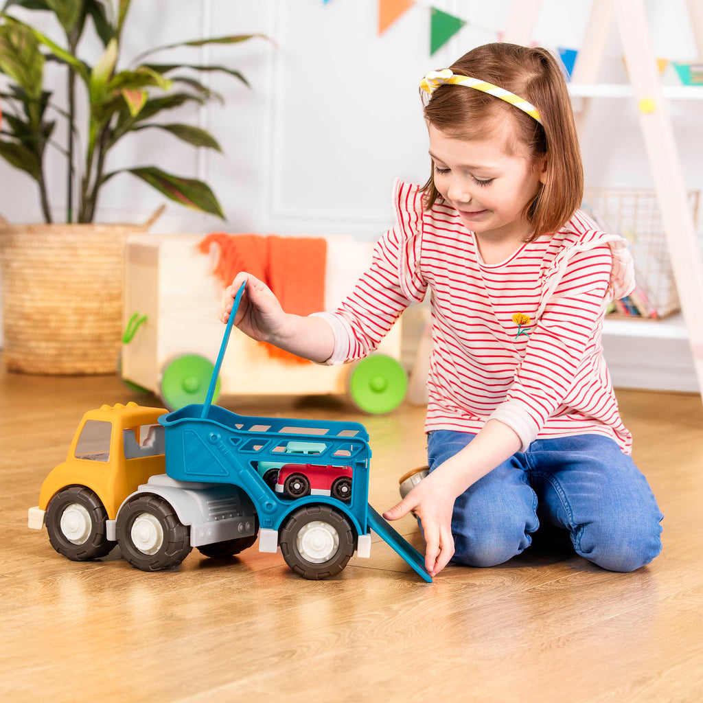 A yellow and blue car carrier truck with 2 toy cars aboard.