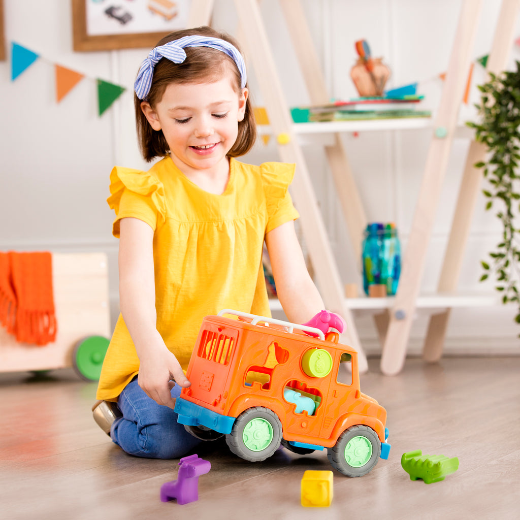 An orange toy truck with shapes to sort.