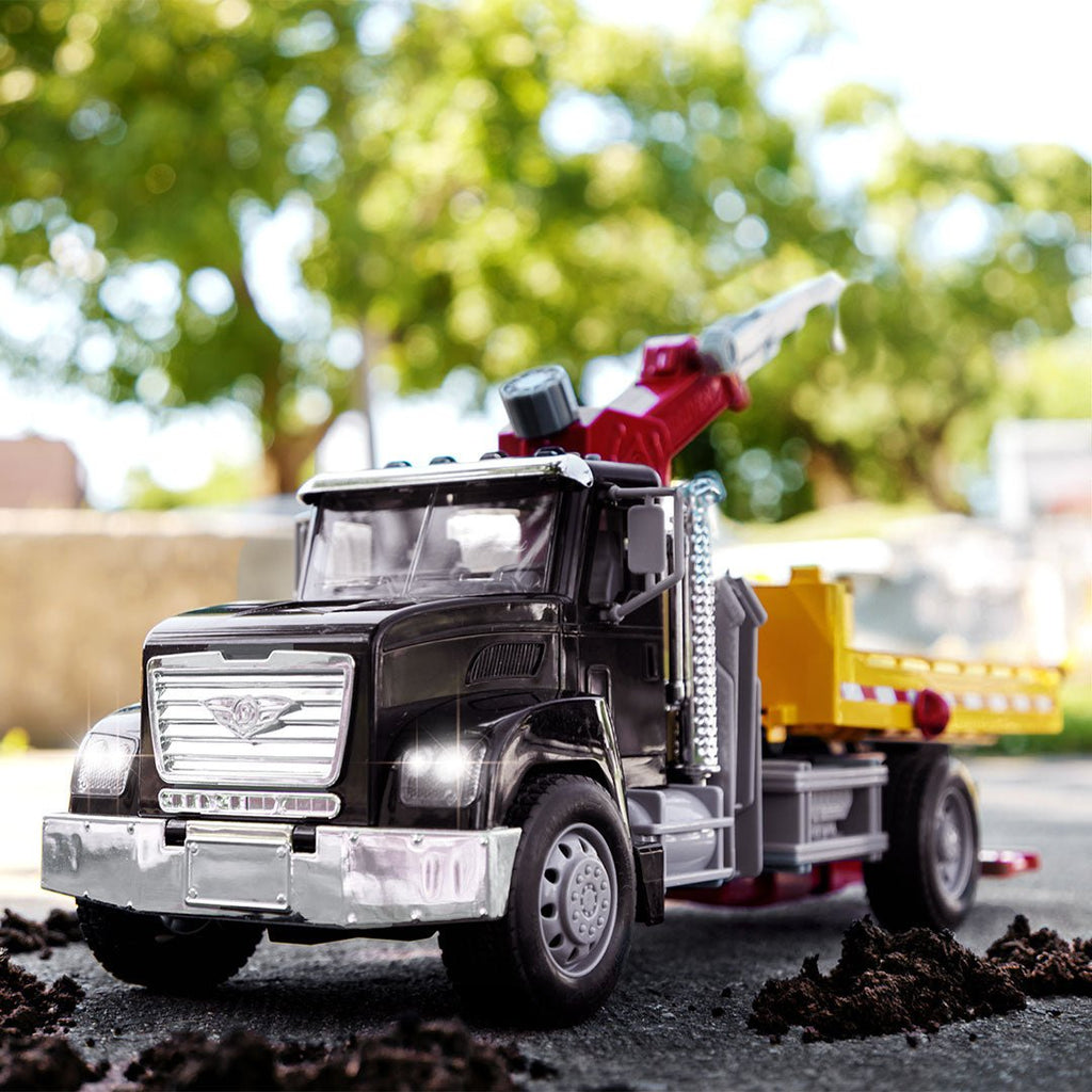 Black toy tow truck towing blue car