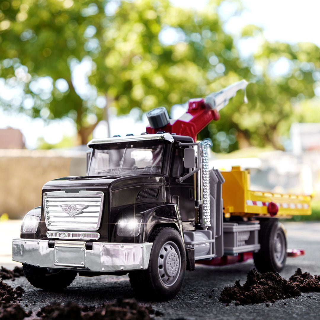 Black toy tow truck towing blue car